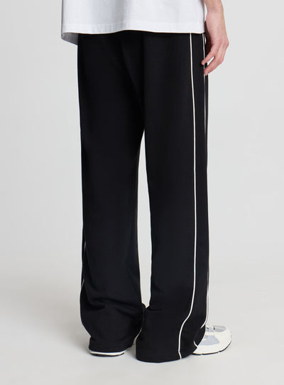 Pantaloni tuta wide leg con piping
