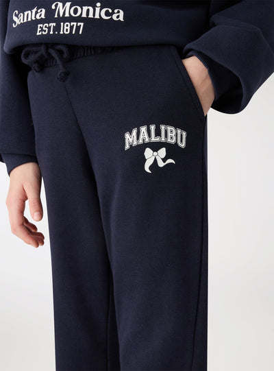 Pantaloni tuta a zampa con stampa college